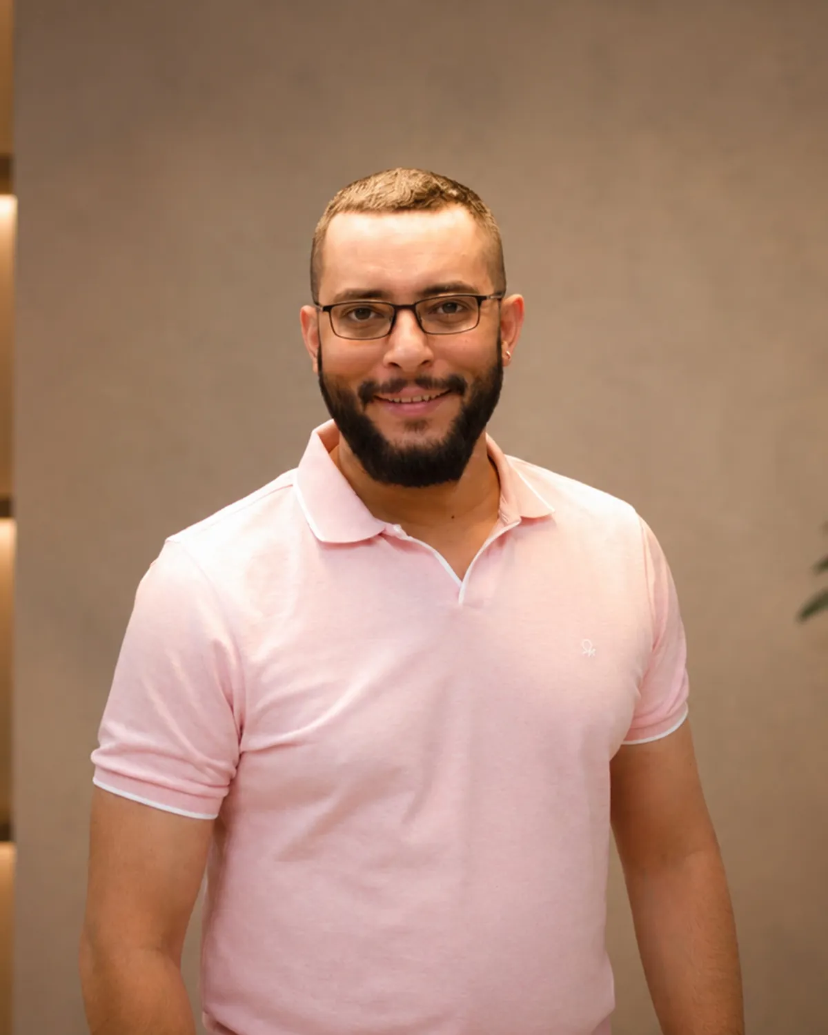 Atulesh Kumar smiling, in a pink polo shirt