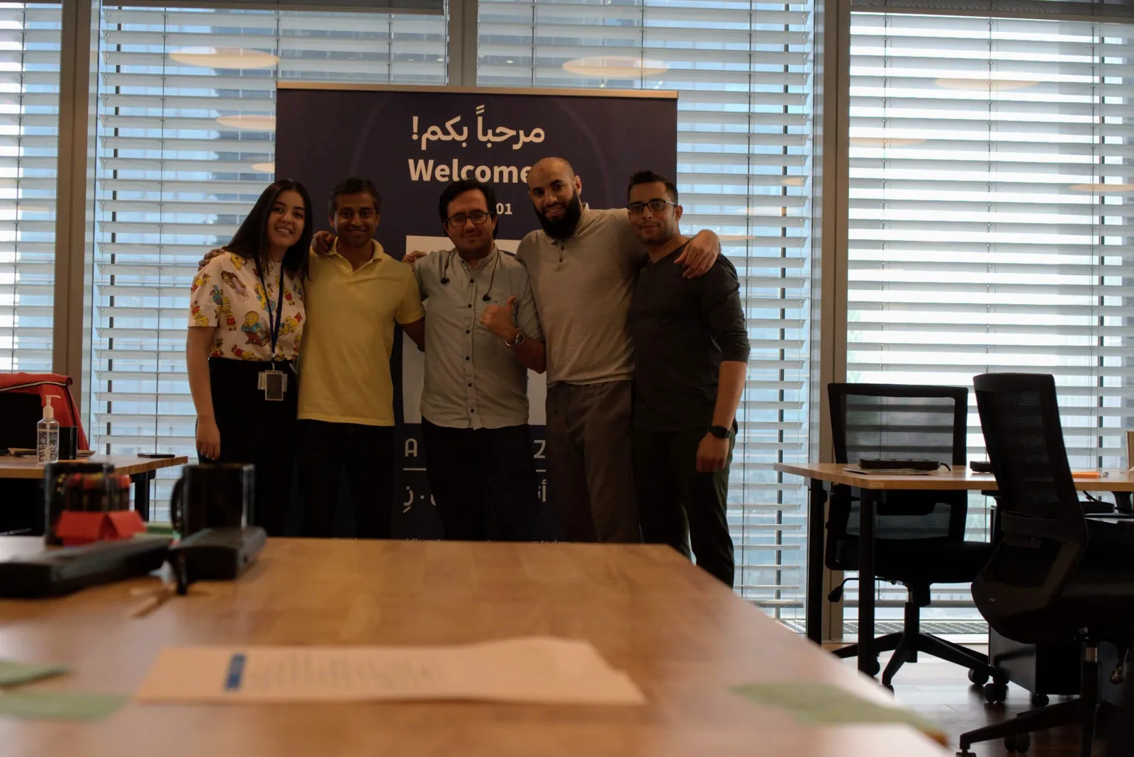 Atulesh with his team in front of the welcome banner